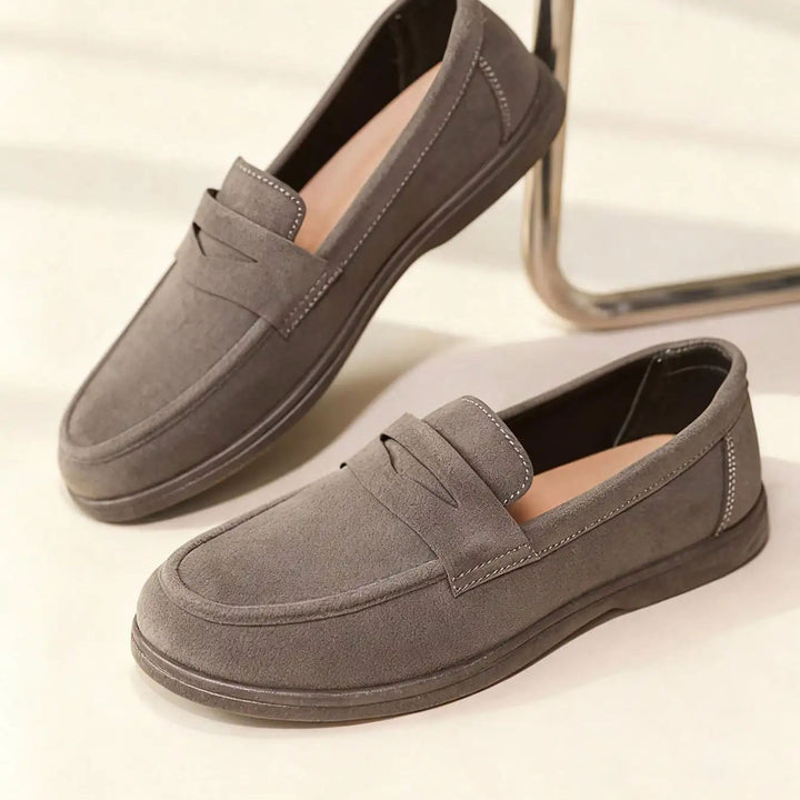Pair of gray loafers on a light background