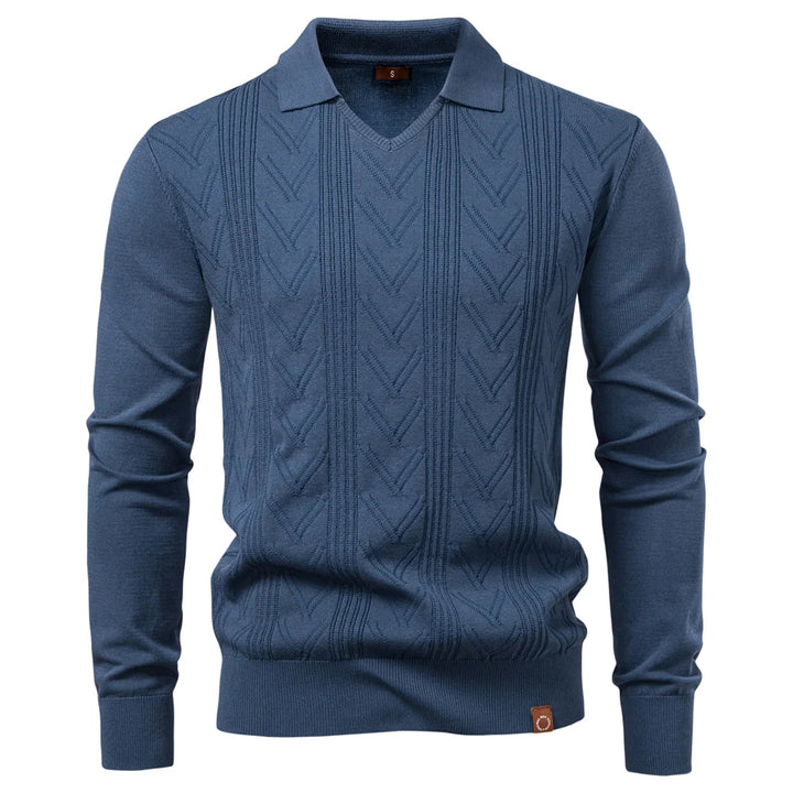 Blue cable knit sweater on a white background
