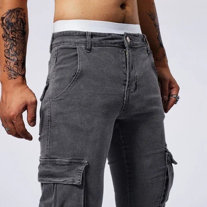 Person wearing gray cargo pants on a white background