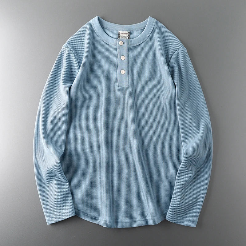 Light blue long-sleeve shirt on a gray background
