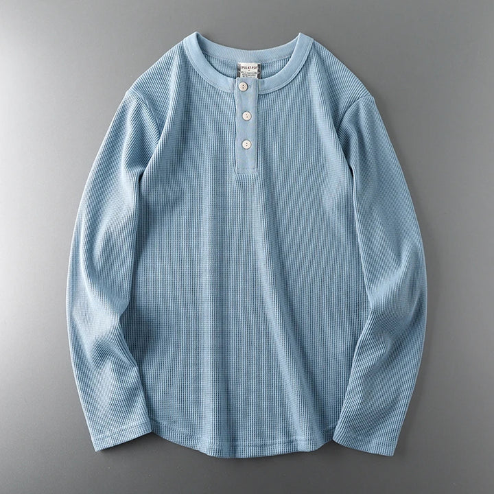 Light blue long-sleeve shirt on a gray background