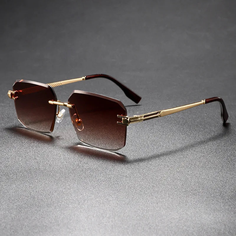 Gold-framed sunglasses with brown gradient lenses on a gray background
