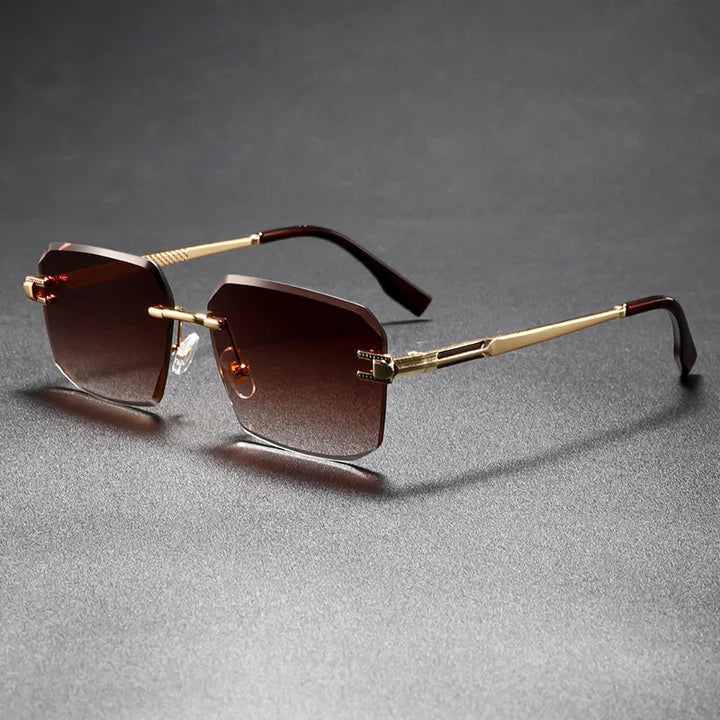 Gold-framed sunglasses with brown gradient lenses on a gray background