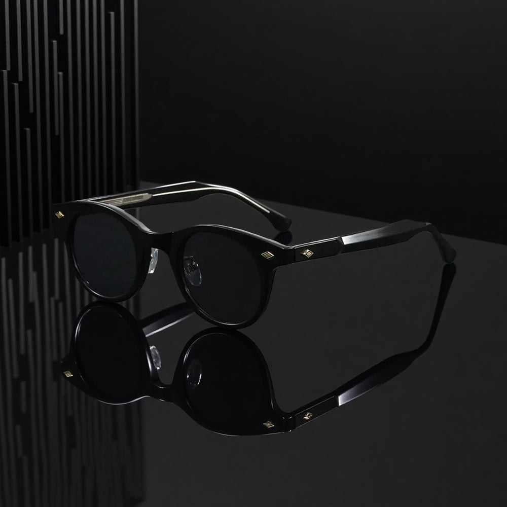 Black sunglasses with reflective surface on a dark background