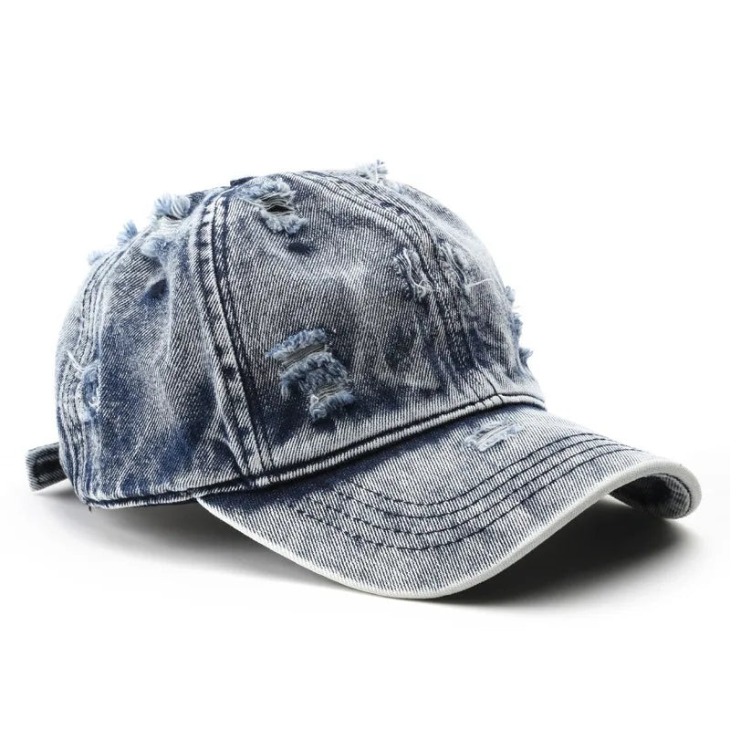 Blue denim cap with worn texture on a white background