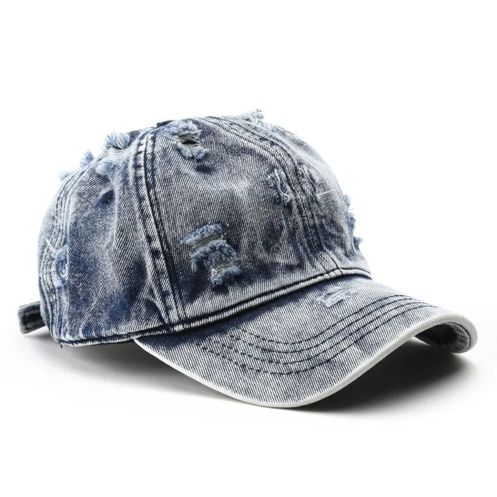 Blue denim cap with worn texture on a white background