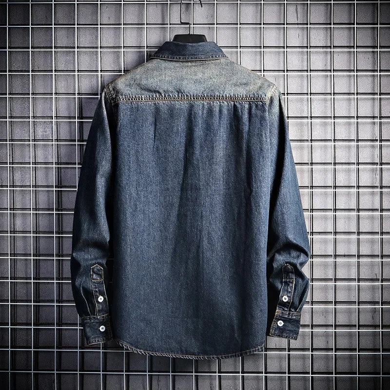 Denim shirt on a hanger against a tiled wall