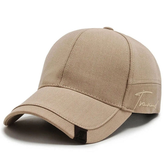 A beige Falcon Twill Curve Cap with a minimalistic design and an adjustable snapback.