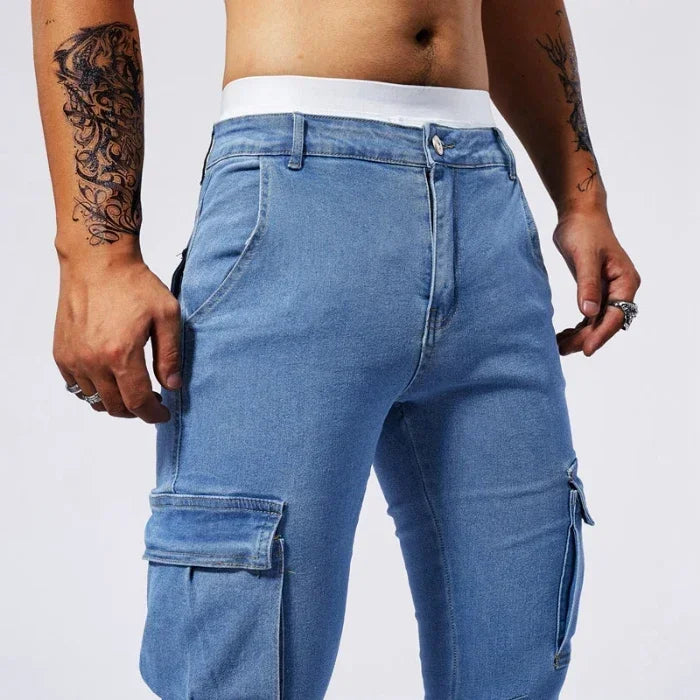 Blue cargo pants worn by a person on a white background