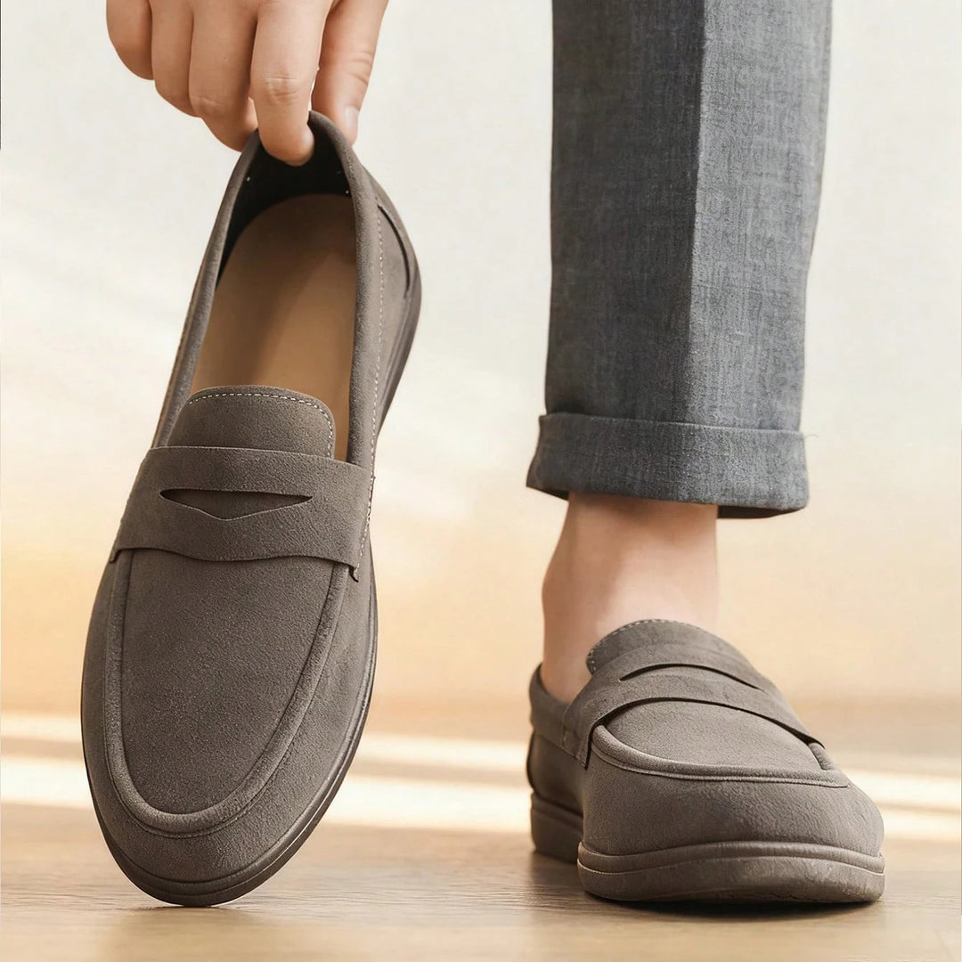Person wearing gray loafers with a blurred background