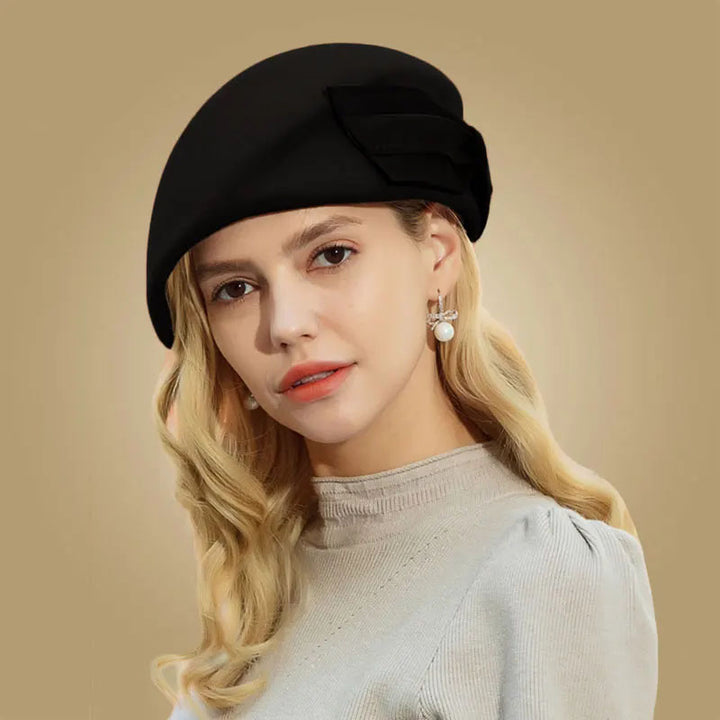 Woman wearing a black beret against a beige background