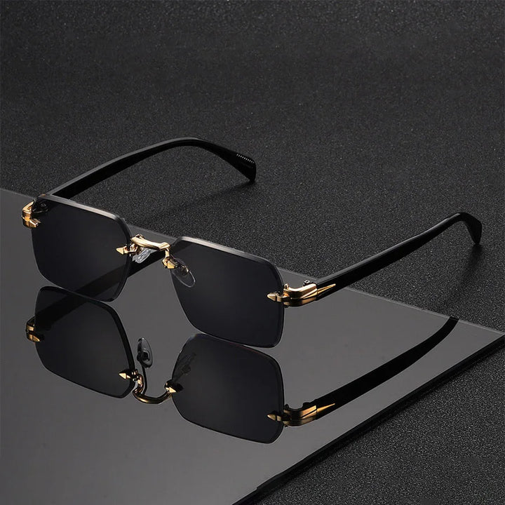 Black sunglasses with gold frames on a reflective black surface