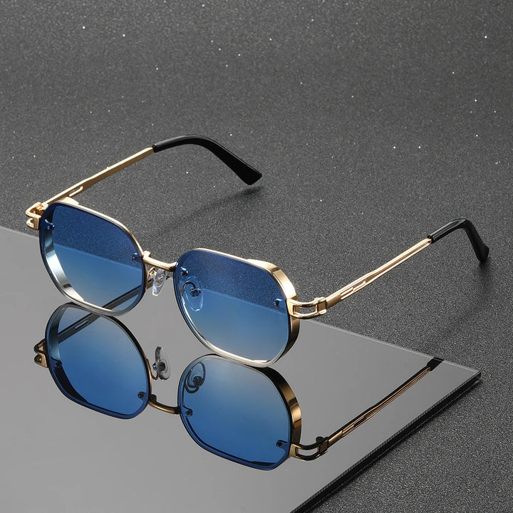Sunglasses with blue lenses and gold frames on a reflective surface