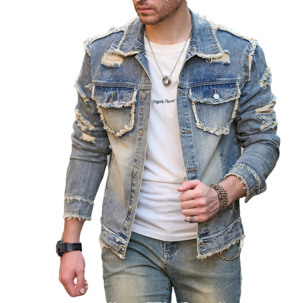 Denim jacket with distressed details worn by a person on a white background