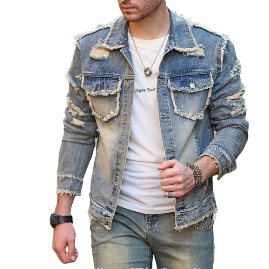 Denim jacket with distressed details worn by a person on a white background