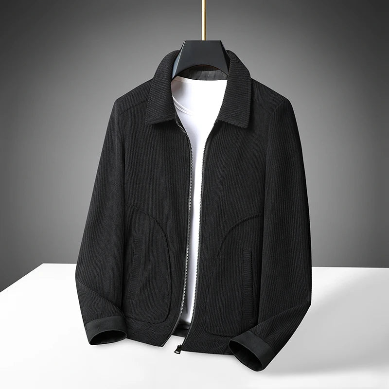 A corduroy coat jacket with a classic lapel design, displayed on a mannequin against a dark background.