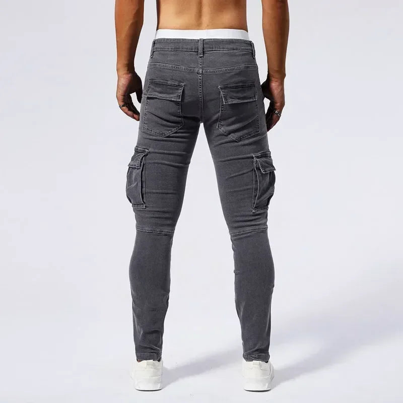 Person wearing gray cargo pants on a white background