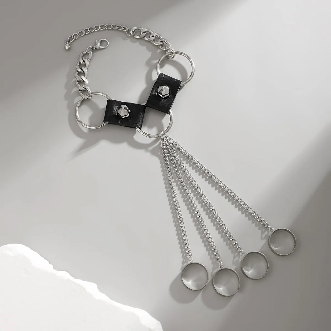 Bracelet with chain and circular elements on a light gray background