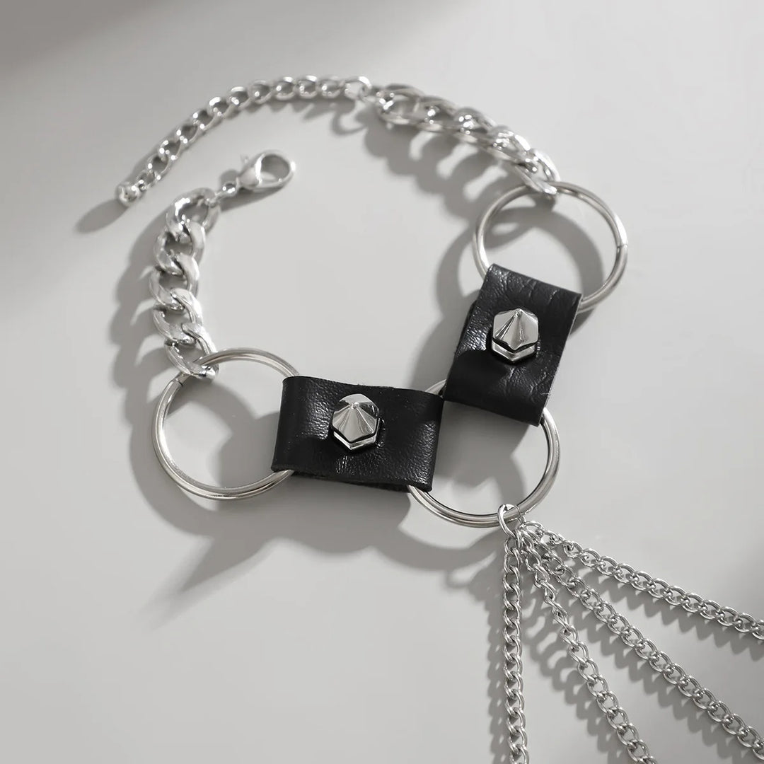 Bracelet with black leather straps and silver chain on a light gray background