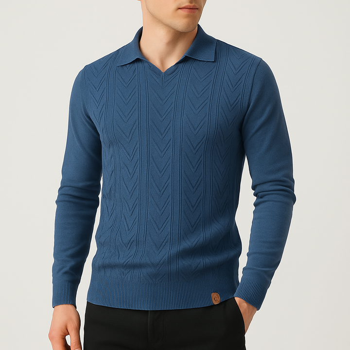 Blue cable knit sweater worn by a person on a light gray background