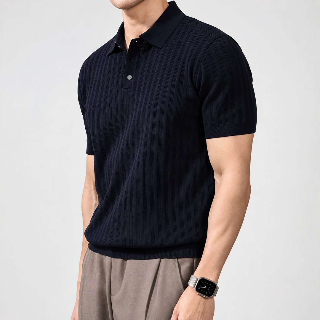 Man wearing a dark blue striped polo shirt on a light gray background