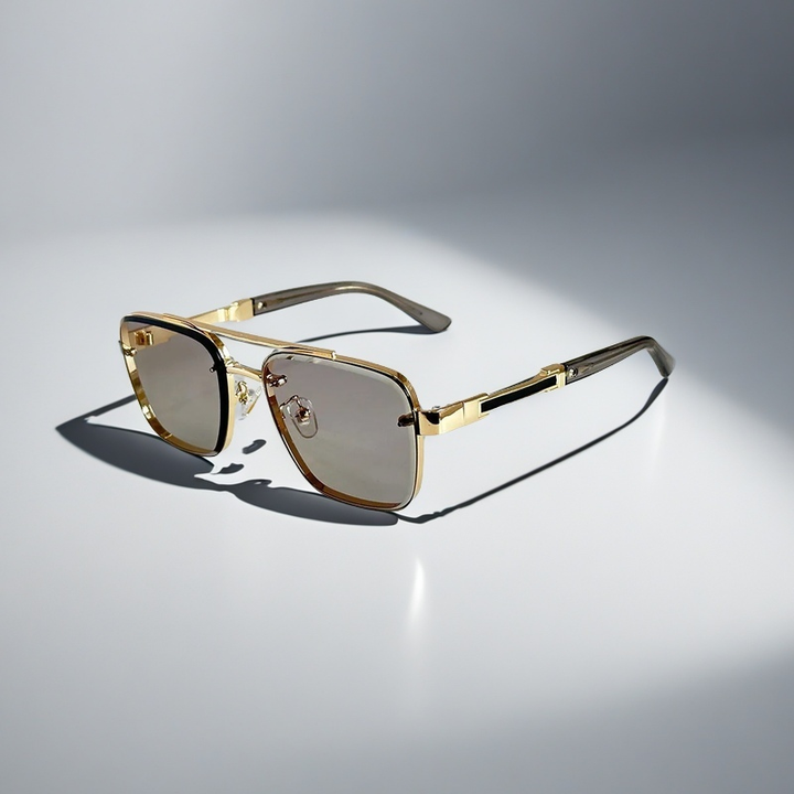 A pair of aviator-style sunglasses with a gold-tone metal frame and gradient lenses.