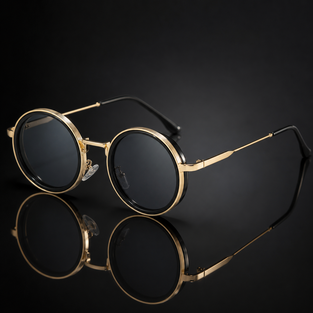 Gold-framed sunglasses with black lenses on a reflective black surface