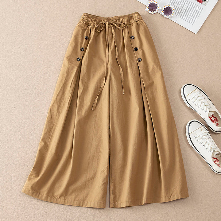 Brown wide-leg pants with buttons on a beige background