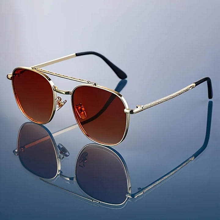 A pair of Lucent Titanium Square Sunglasses with blue polarized lenses and a metallic gold frame, displayed on a reflective surface.