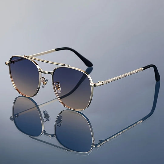 A pair of Lucent Titanium Square Sunglasses with blue polarized lenses and a metallic gold frame, displayed on a reflective surface.