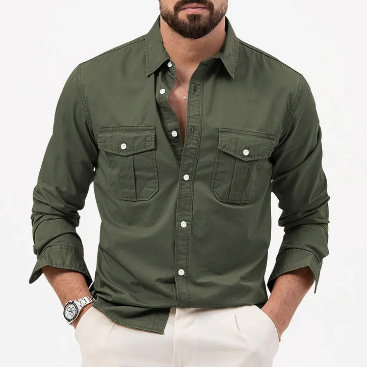 A man wearing a green military-inspired long-sleeved shirt with two chest pockets.