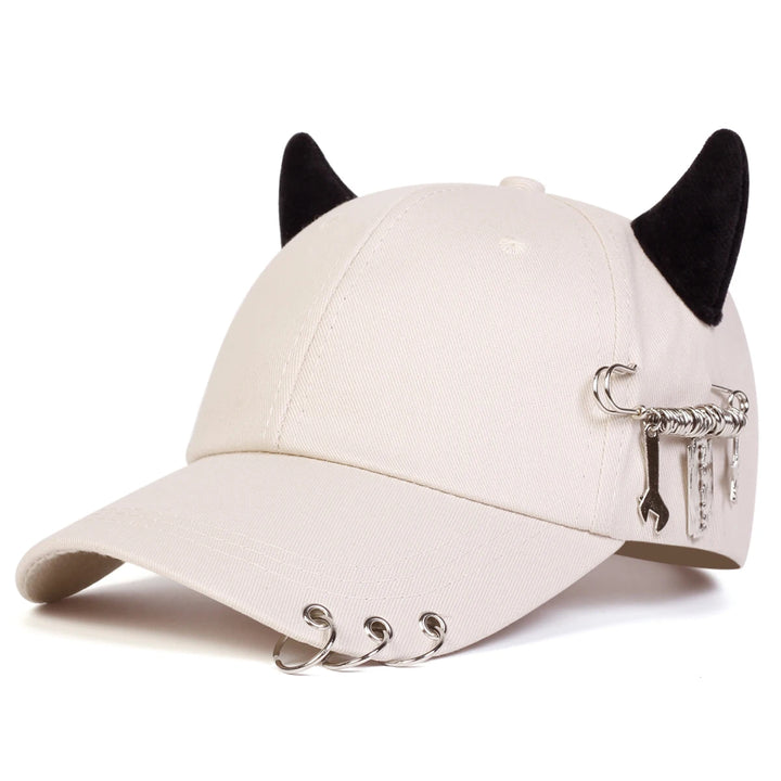 Beige cap with black cat ears and metal cat emblem on a white background