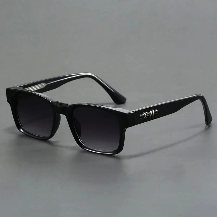 A pair of square-shaped, black acetate sunglasses with tortoiseshell details and UV400 protection.