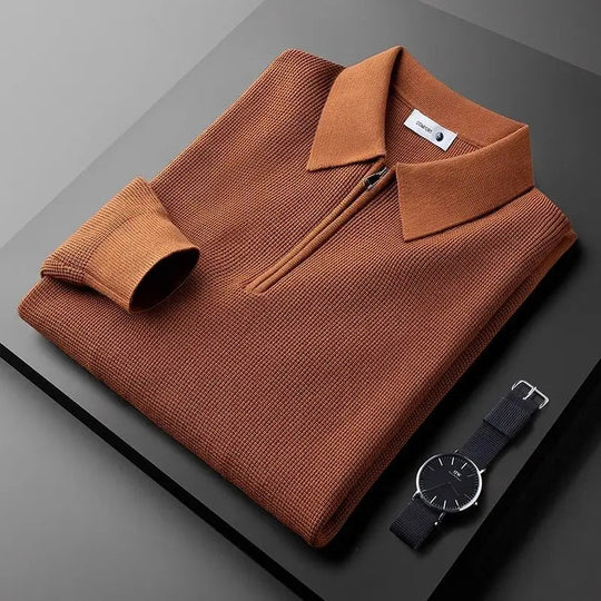 Folded long sleeve polo shirt in brown with a waffle knit texture and a half zipper at the front.