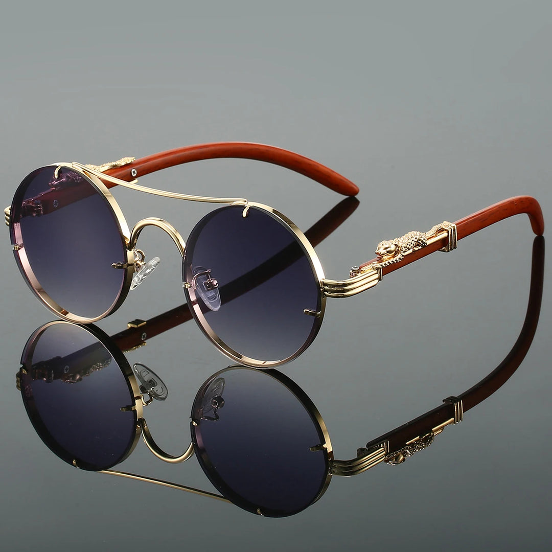 A pair of round-shaped, vintage style sunglasses with a double bridge design and intricately detailed temples. The lenses are tinted blue, and the overall color scheme includes gold and red.