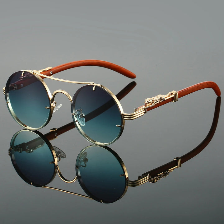 A pair of round-shaped, vintage style sunglasses with a double bridge design and intricately detailed temples. The lenses are tinted blue, and the overall color scheme includes gold and red.