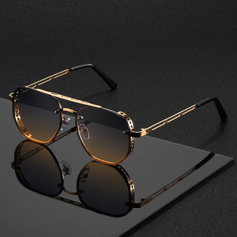 Gold-framed sunglasses with dark lenses on a reflective black surface