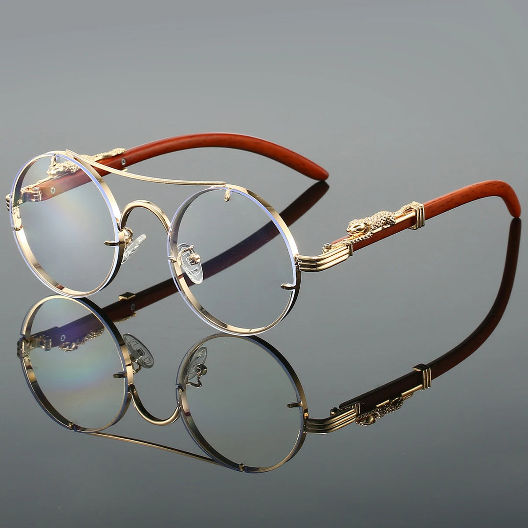 A pair of round-shaped, vintage style sunglasses with a double bridge design and intricately detailed temples. The lenses are tinted blue, and the overall color scheme includes gold and red.