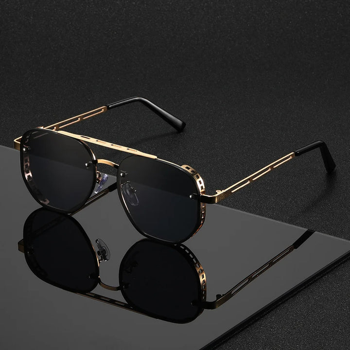 Gold-framed sunglasses with black lenses on a reflective surface