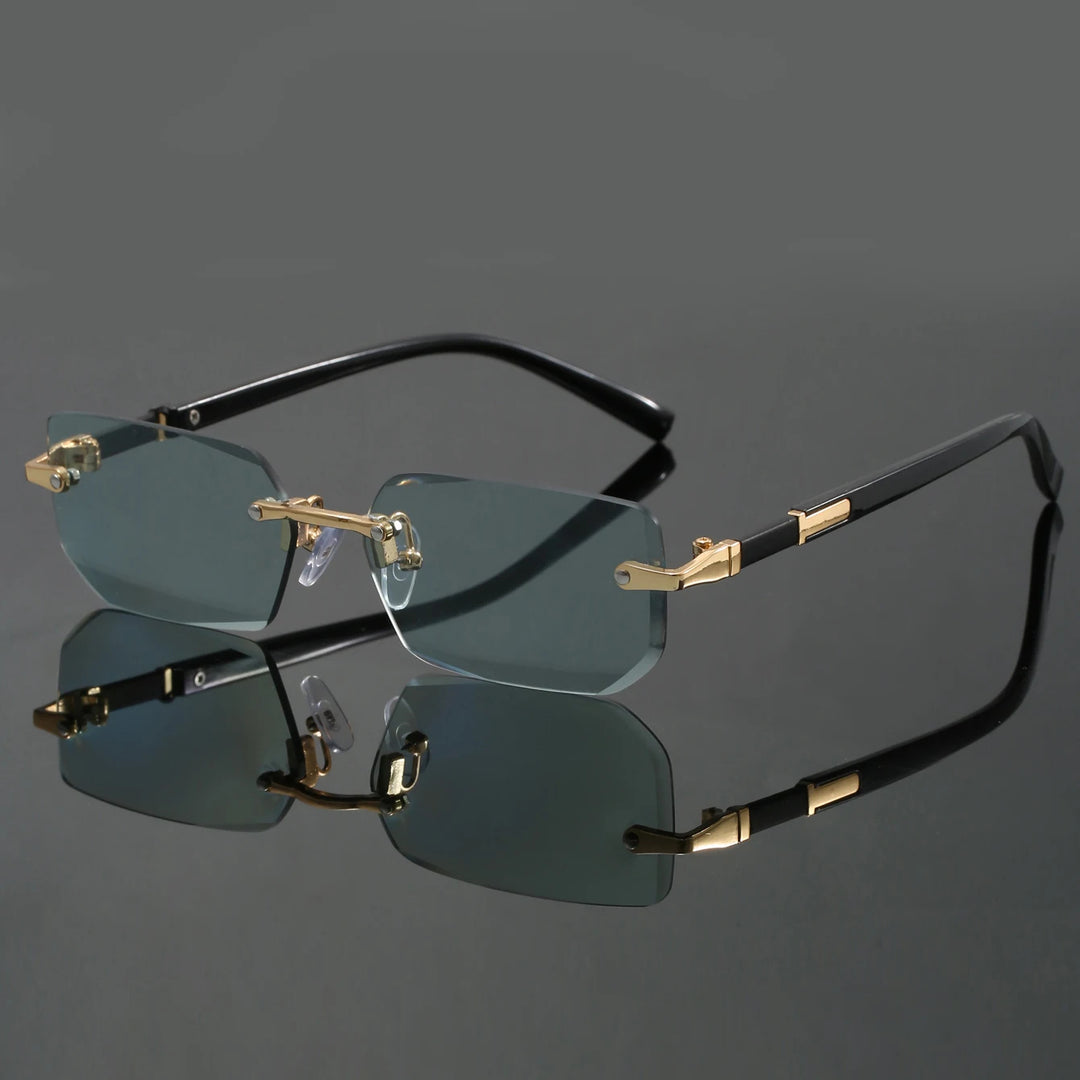 A pair of rimless sunglasses with cut-edge lenses and a frameless design. The sunglasses are black with gold accents on the hinges and corners.