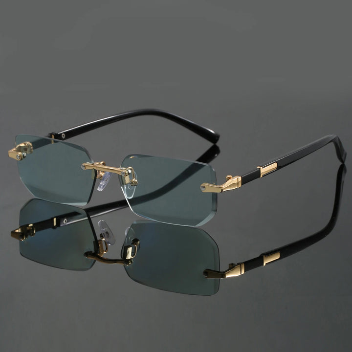 A pair of rimless sunglasses with cut-edge lenses and a frameless design. The sunglasses are black with gold accents on the hinges and corners.