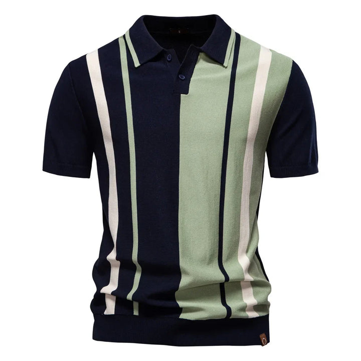 A person wearing a navy blue and green vertical striped knit polo shirt with a collar.
