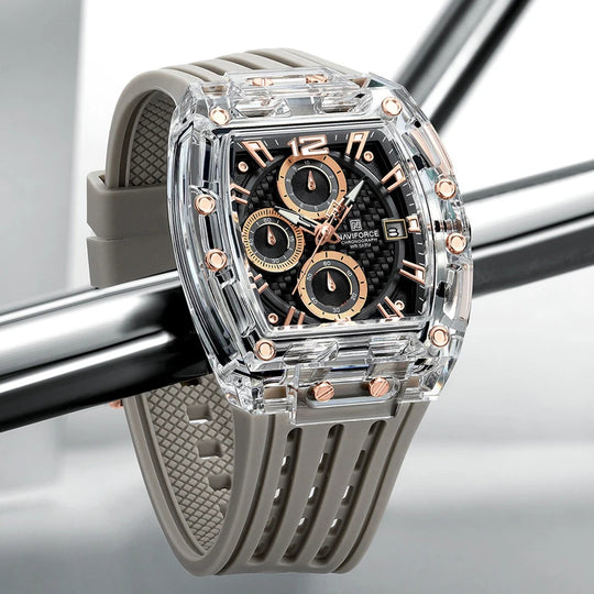A sporty watch with a silicone strap and a clear acrylic crystal dial, featuring rose gold hands and markers, and a date display.