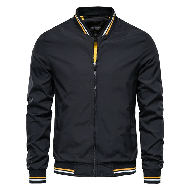 A black Valor Ascend bomber jacket with yellow trim on the collar and cuffs.