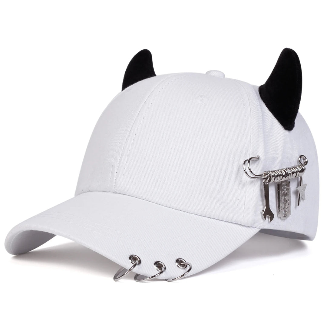 White cap with black cat ears and metal embellishments on a white background