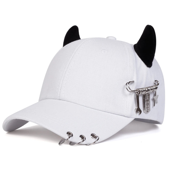White cap with black cat ears and metal embellishments on a white background